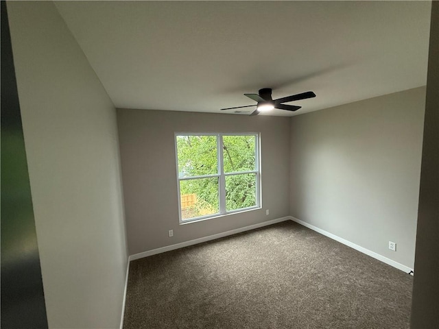 1141 Walnut Ave, Osawatomie, KS 66064 - empty room featuring baseboards, dark colored carpet, and a ceiling fan