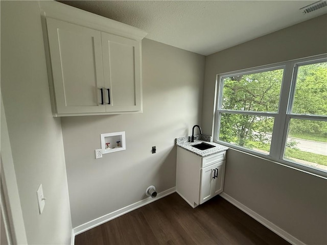 1141 Walnut Ave, Osawatomie, KS 66064 - laundry area featuring baseboards, washer hookup, dark wood-style floors, electric dryer hookup, and cabinet space