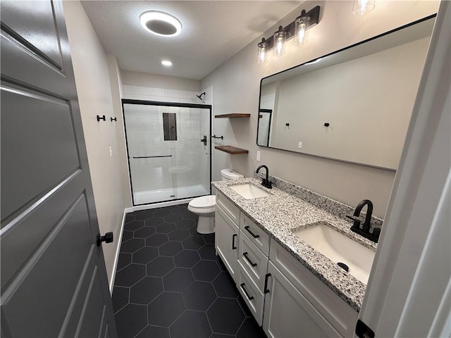 1141 Walnut Ave, Osawatomie, KS 66064 - full bath featuring double vanity, toilet, a tile shower, tile patterned floors, and recessed lighting