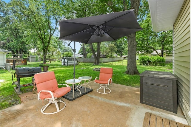 4820 Stearns Ln, Shawnee, KS 66203 - fenced backyard with a storage unit, a patio area, and grilling area