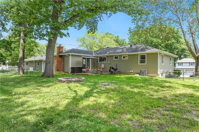 4820 Stearns Ln, Shawnee, KS 66203 - rear view of property with an outdoor fire pit and a patio area