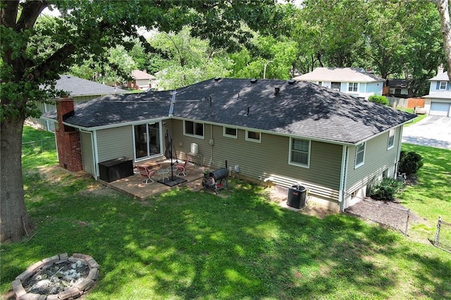 4820 Stearns Ln, Shawnee, KS 66203 - rear view of property featuring entry steps, a patio area, roof with shingles, and a chimney