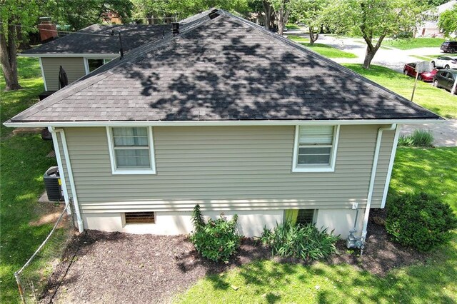 4820 Stearns Ln, Shawnee, KS 66203 - view of side of property featuring a shingled roof and a lawn