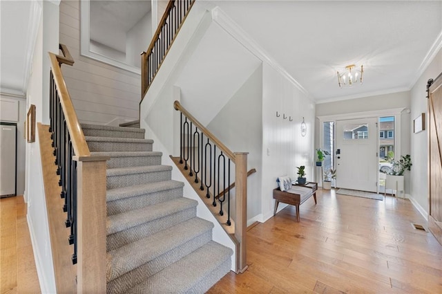 1505 SW Georgetown Dr, Lees Summit, MO 64082 - foyer with stairs, light wood-style flooring, crown molding, a chandelier, and baseboards