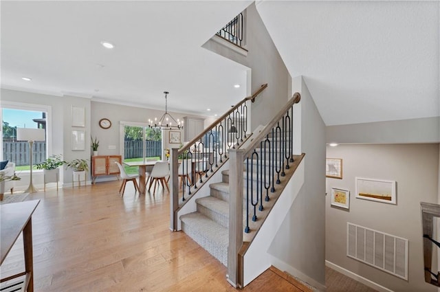 1505 SW Georgetown Dr, Lees Summit, MO 64082 - stairs with baseboards, wood finished floors, a chandelier, recessed lighting, and a baseboard heating unit