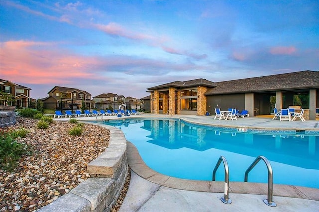 1505 SW Georgetown Dr, Lees Summit, MO 64082 - pool at dusk with a community pool, a patio, and a residential view