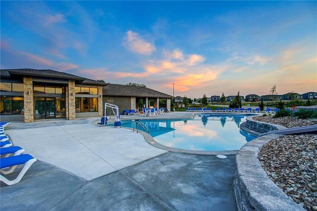 1505 SW Georgetown Dr, Lees Summit, MO 64082 - pool at dusk with a patio and a community pool