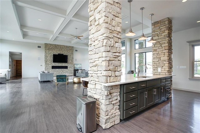 1505 SW Georgetown Dr, Lees Summit, MO 64082 - kitchen featuring a sink, decorative columns, dark wood-type flooring, beamed ceiling, and ceiling fan