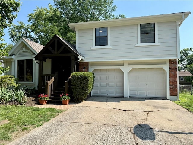 5341 Locust Ln, Kansas City, KS 66106 - view of front of home with brick siding, a garage, and driveway