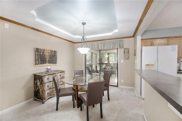 5341 Locust Ln, Kansas City, KS 66106 - dining room featuring a tray ceiling, ornamental molding, and light carpet