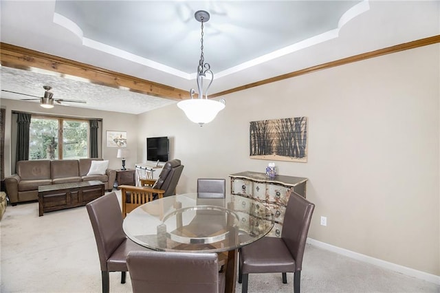 5341 Locust Ln, Kansas City, KS 66106 - dining room featuring carpet floors, a tray ceiling, and a ceiling fan