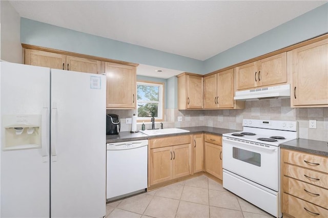5341 Locust Ln, Kansas City, KS 66106 - kitchen with white appliances, under cabinet range hood, light brown cabinetry, and dark countertops