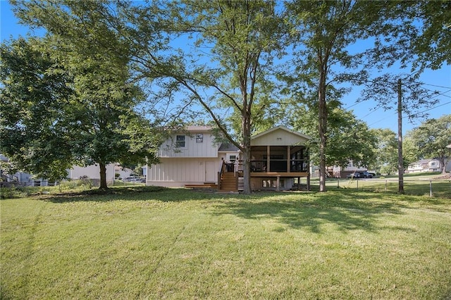 5341 Locust Ln, Kansas City, KS 66106 - back of house featuring stairs, a sunroom, and a wooden deck