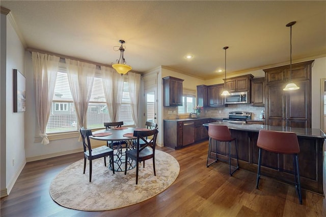 3201 SE 3rd St, Lees Summit, MO 64063 - dining area with dark wood-style flooring, ornamental molding, and recessed lighting