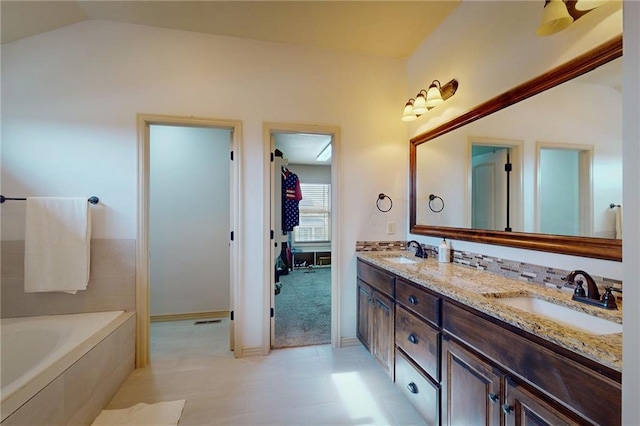 3201 SE 3rd St, Lees Summit, MO 64063 - full bath featuring a garden tub, double vanity, lofted ceiling, and tile patterned flooring