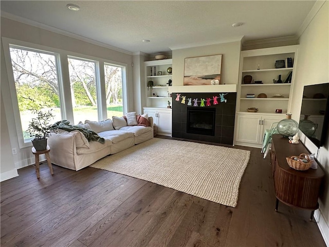 3117 SW Arbor Tree Dr, Lees Summit, MO 64082 - living room with plenty of natural light, dark wood finished floors, a tiled fireplace, crown molding, and built in shelves