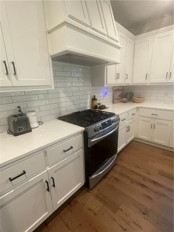 3117 SW Arbor Tree Dr, Lees Summit, MO 64082 - kitchen featuring stainless steel range with gas cooktop, premium range hood, dark wood finished floors, white cabinetry, and backsplash