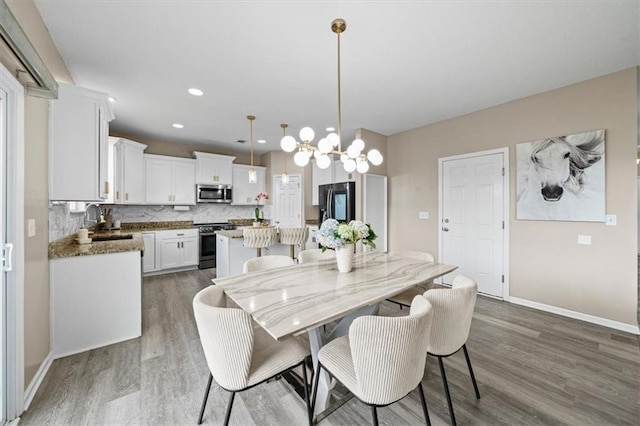1420 SW Cornwall Rd, Lees Summit, MO 64083 - dining room featuring wood finished floors, a chandelier, and recessed lighting