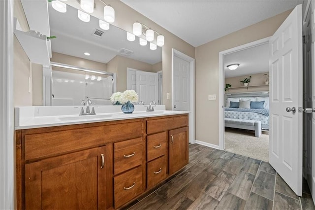 1420 SW Cornwall Rd, Lees Summit, MO 64083 - ensuite bathroom with double vanity, a stall shower, and wood finished floors