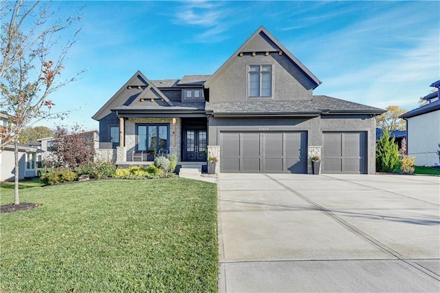17029 King St, Overland Park, KS 66221 - view of front facade with a front yard, stucco siding, concrete driveway, stone siding, and a garage