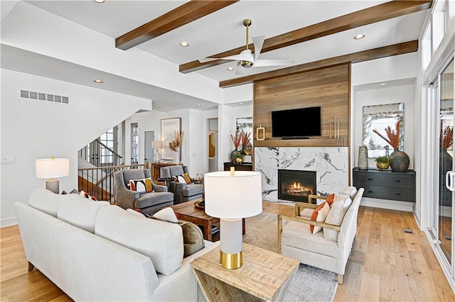17029 King St, Overland Park, KS 66221 - living room featuring ceiling fan, a fireplace, light wood-style floors, recessed lighting, and stairway