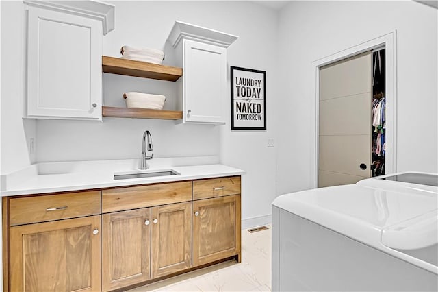 17029 King St, Overland Park, KS 66221 - washroom with light marble finish flooring, cabinet space, and washing machine and clothes dryer