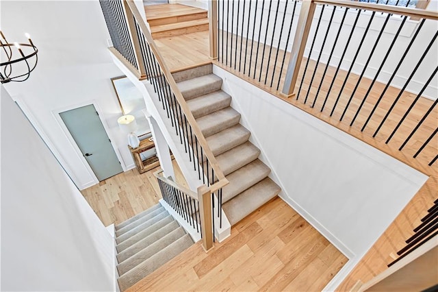 17029 King St, Overland Park, KS 66221 - stairway featuring a towering ceiling, wood finished floors, and a chandelier