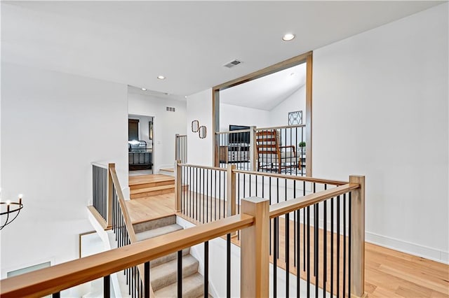 17029 King St, Overland Park, KS 66221 - corridor with an upstairs landing, wood finished floors, recessed lighting, baseboards, and a chandelier