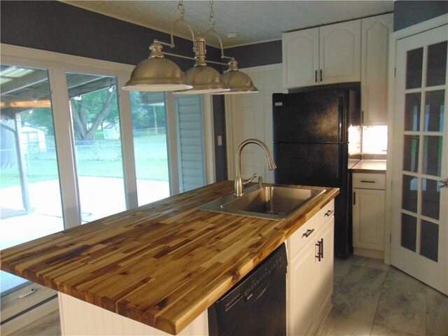 241 E S St, Peculiar, MO 64078 - kitchen featuring butcher block counters, black appliances, a kitchen island with sink, white cabinetry, and hanging light fixtures