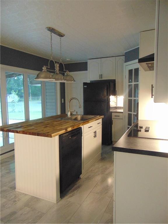241 E S St, Peculiar, MO 64078 - kitchen with black appliances, healthy amount of natural light, butcher block countertops, and white cabinetry