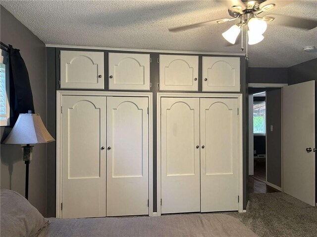 241 E S St, Peculiar, MO 64078 - unfurnished bedroom with a textured ceiling, carpet floors, a ceiling fan, and a closet