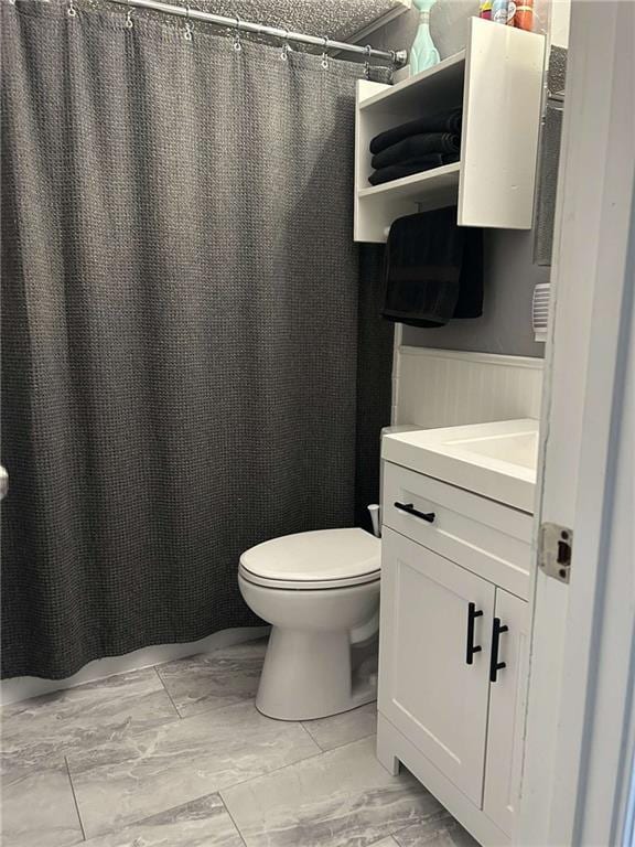 241 E S St, Peculiar, MO 64078 - bathroom with marble look tiles, vanity, and a shower with curtain