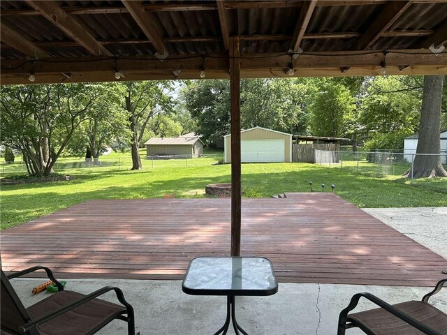 241 E S St, Peculiar, MO 64078 - deck with a fenced backyard and an outbuilding