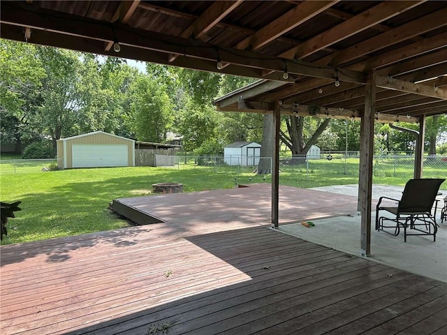 241 E S St, Peculiar, MO 64078 - wooden deck with a fenced backyard, an outdoor fire pit, a shed, a patio, and a detached garage