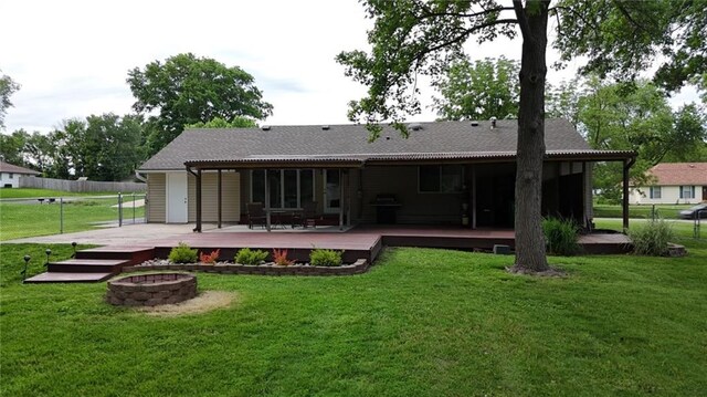 241 E S St, Peculiar, MO 64078 - back of property with a fire pit and a deck