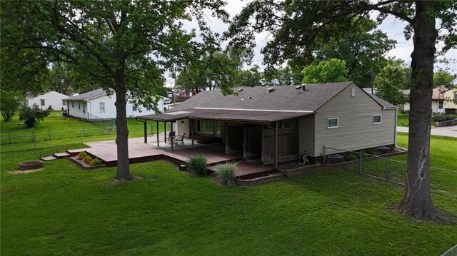 241 E S St, Peculiar, MO 64078 - back of house featuring a fenced backyard, a deck, and roof with shingles