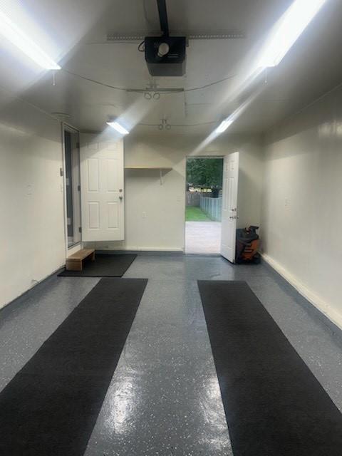 241 E S St, Peculiar, MO 64078 - garage with a garage door opener and baseboards