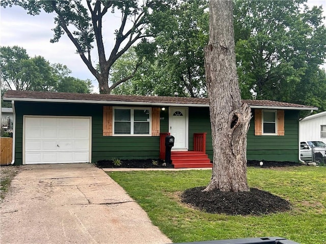 409 N Geronimo Dr, Independence, MO 64056 - view of front of house with an attached garage, a front yard, and driveway
