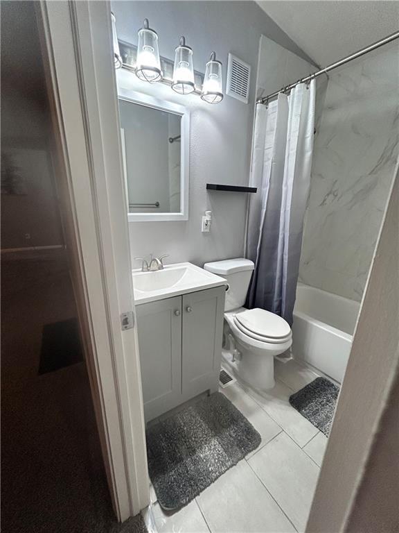 409 N Geronimo Dr, Independence, MO 64056 - bathroom with vanity, shower / bathtub combination with curtain, and tile patterned floors