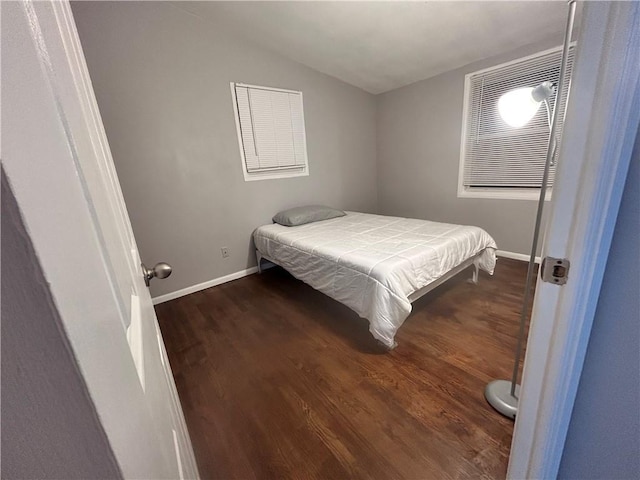 409 N Geronimo Dr, Independence, MO 64056 - bedroom with vaulted ceiling and dark wood-type flooring