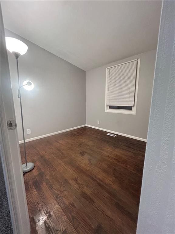 409 N Geronimo Dr, Independence, MO 64056 - empty room with dark wood-type flooring and baseboards