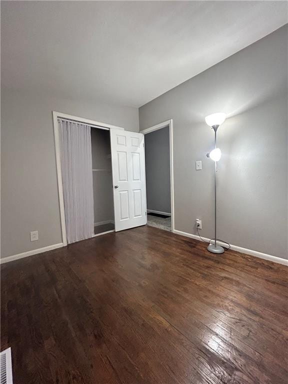 409 N Geronimo Dr, Independence, MO 64056 - unfurnished bedroom featuring wood finished floors and a closet