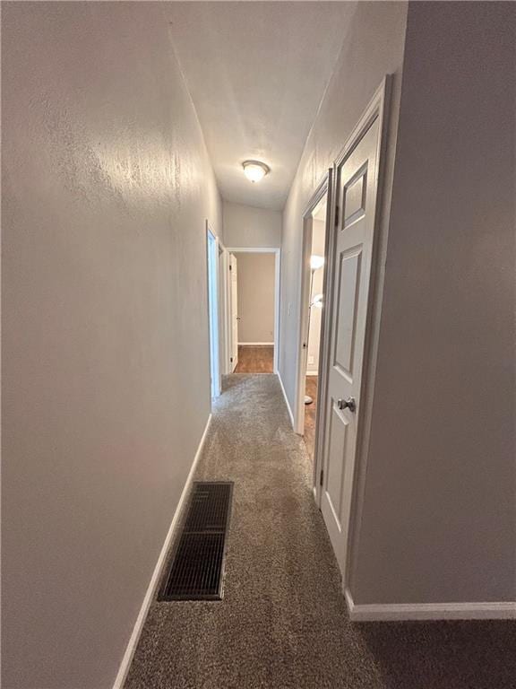 409 N Geronimo Dr, Independence, MO 64056 - hall with baseboards and carpet flooring
