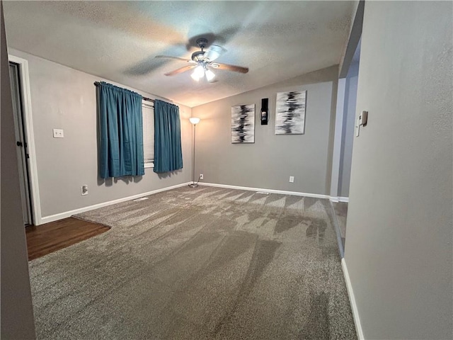 409 N Geronimo Dr, Independence, MO 64056 - empty room featuring a ceiling fan, lofted ceiling, a textured ceiling, and carpet