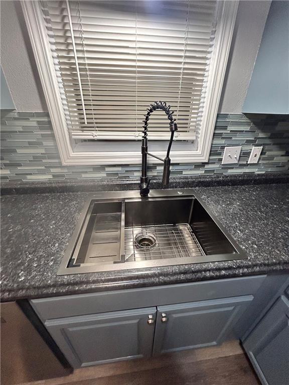 409 N Geronimo Dr, Independence, MO 64056 - kitchen view of a sink and tasteful backsplash