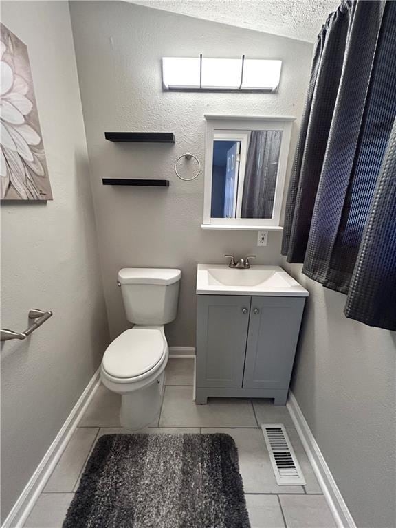409 N Geronimo Dr, Independence, MO 64056 - bathroom featuring tile patterned floors, vanity, and a textured ceiling