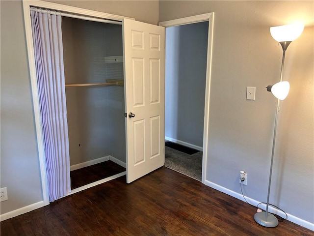 409 N Geronimo Dr, Independence, MO 64056 - unfurnished bedroom featuring dark wood-type flooring and a closet