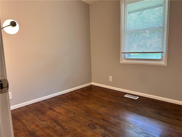 409 N Geronimo Dr, Independence, MO 64056 - unfurnished room featuring baseboards and dark wood finished floors