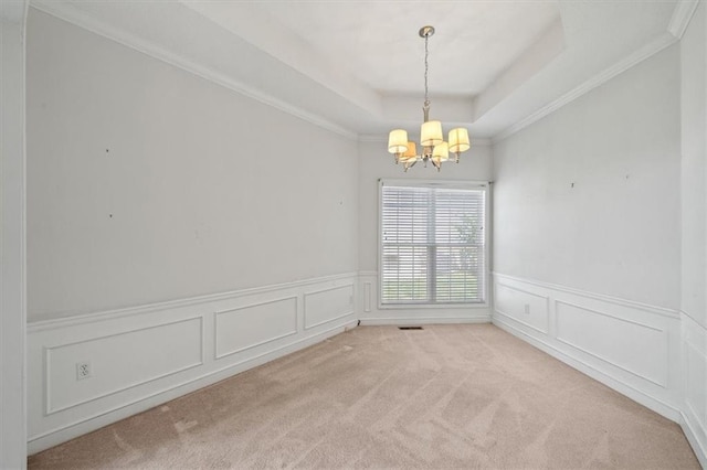 7633 W 148th Ter, Overland Park, KS 66223 - unfurnished room featuring a chandelier, a raised ceiling, light colored carpet, a wainscoted wall, and crown molding