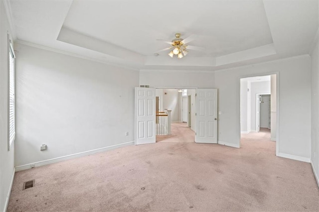 7633 W 148th Ter, Overland Park, KS 66223 - unfurnished bedroom featuring a raised ceiling, light carpet, and ceiling fan